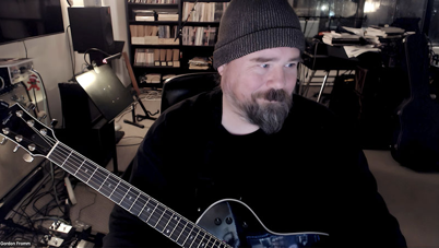 Gordon Fromm playing guitar in his studio